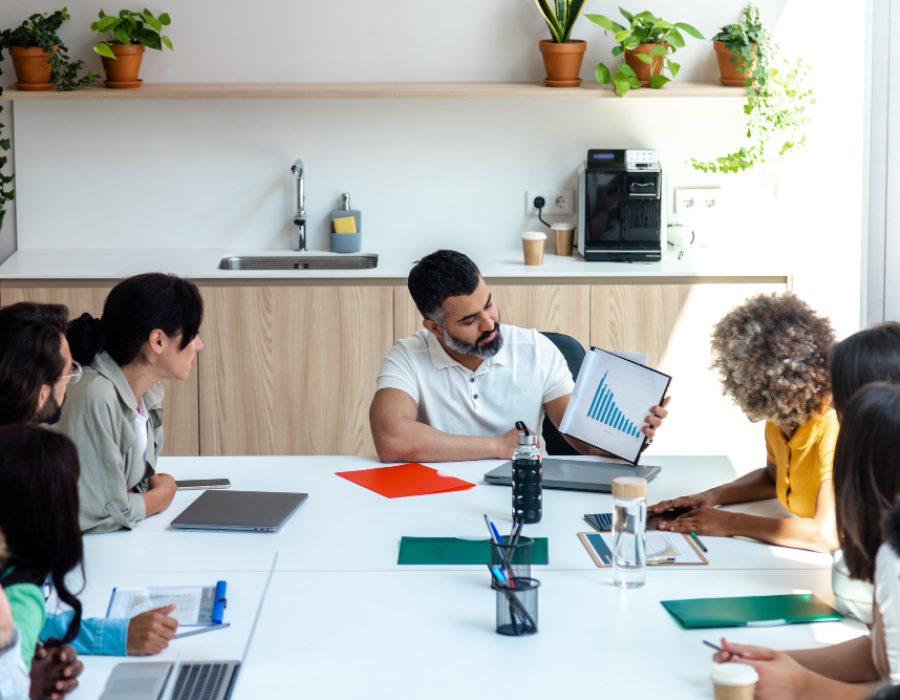 indian-boss-shows-business-evolution-graphs-employees-office-copy-space-business-meeting